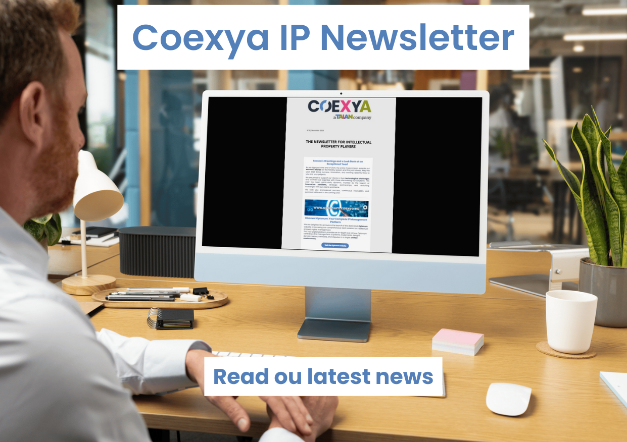 Image of a man at his desk reading a newsletter on his computer to illustrate the release of Coexya's newsletter on intellectual property.